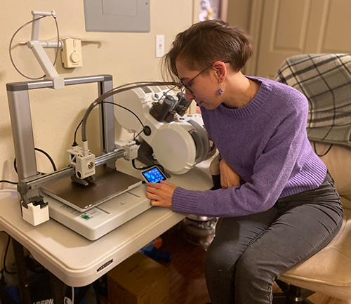 A graduate student uses a 3D printer from home.