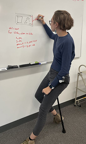 A woman writing on a white board