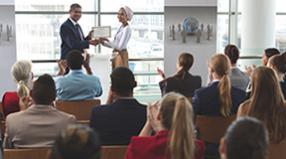 A person accepts an award in front of a crowd