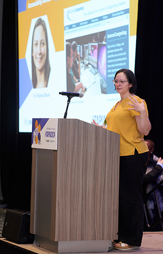 Brianna speaking behind a podium at the Tapia conference