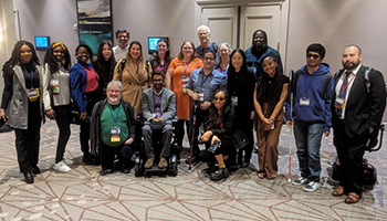 AccessComputing staff, partners, students, and friends in a foyer at CRA-WP