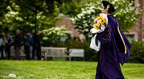 A PhD graduate walks to their ceremony